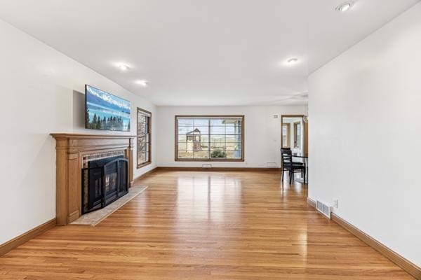 unfurnished living room with light wood-type flooring