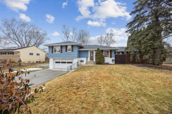 view of front of home with a garage and a front yard