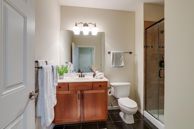 bathroom featuring tile patterned flooring, vanity, toilet, and a shower with shower door