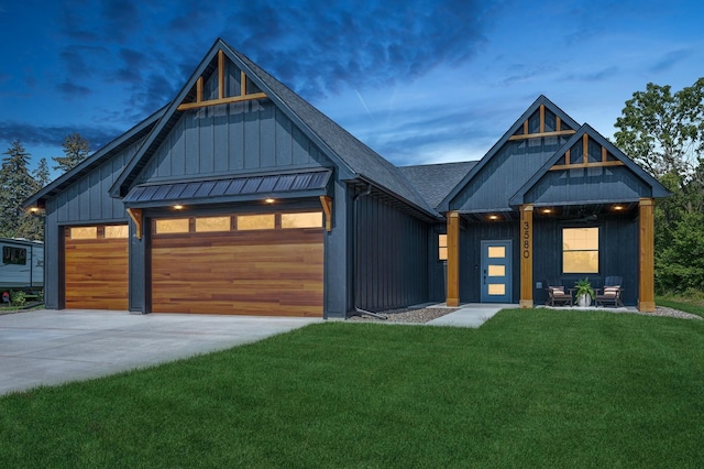 modern farmhouse with a yard and a garage