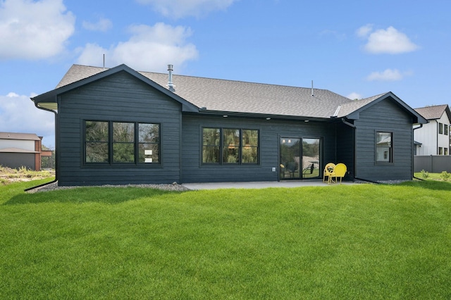 rear view of property featuring a patio area and a lawn