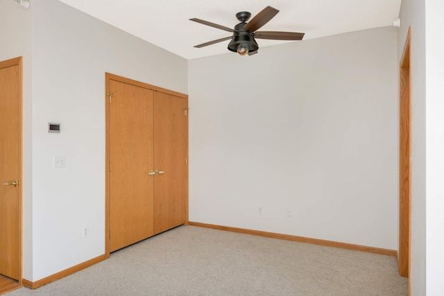 unfurnished bedroom with a closet, ceiling fan, and light colored carpet