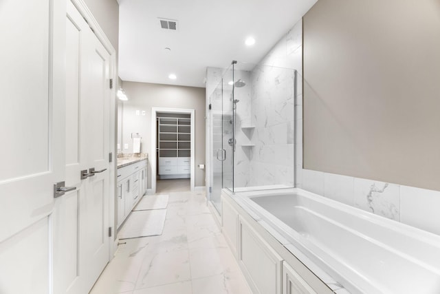 bathroom featuring vanity and separate shower and tub