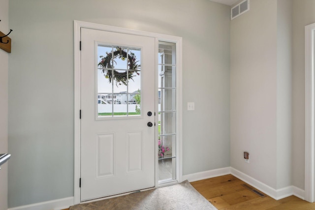 entryway with hardwood / wood-style floors