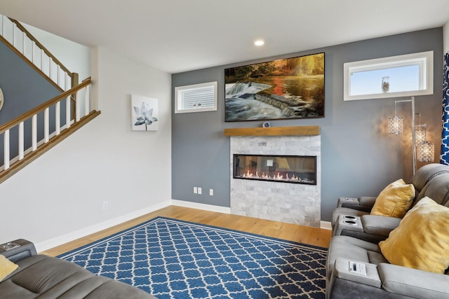 living room featuring wood-type flooring and a fireplace