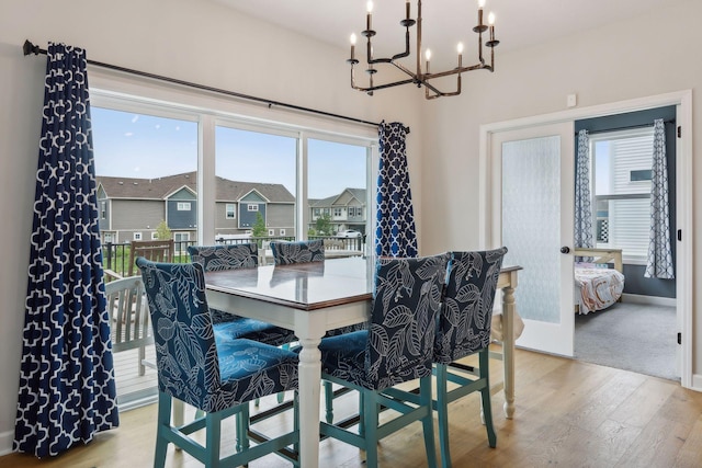 dining room featuring light hardwood / wood-style flooring, an inviting chandelier, and plenty of natural light