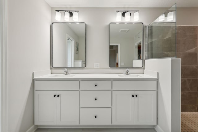 bathroom with vanity and a tile shower