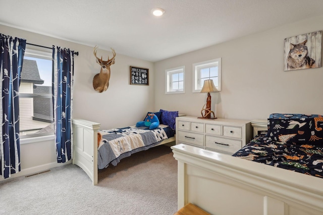 carpeted bedroom with multiple windows