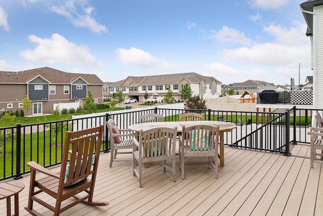 wooden terrace featuring a lawn