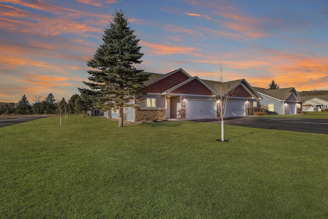 view of front of home with a garage, stone siding, aphalt driveway, and a lawn