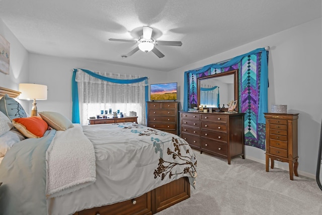 bedroom with a ceiling fan, carpet, a textured ceiling, and baseboards