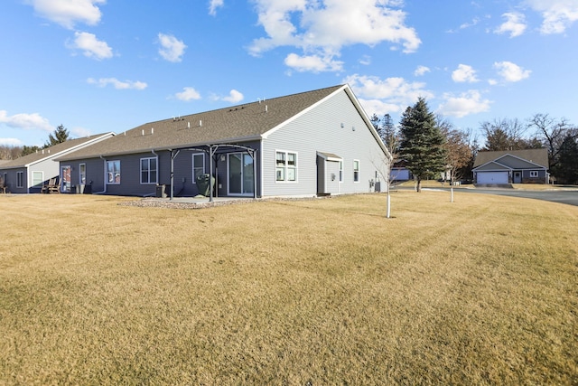 back of property featuring a lawn