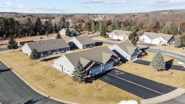 bird's eye view featuring a residential view and a wooded view