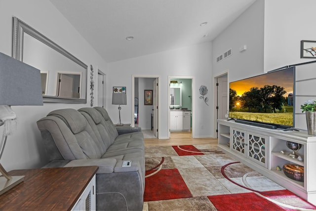 living area with high vaulted ceiling, wood finished floors, visible vents, and recessed lighting
