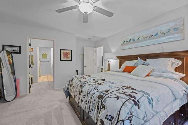carpeted bedroom featuring baseboards and a ceiling fan