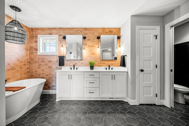 bathroom with vanity, tile patterned flooring, a tub, and toilet