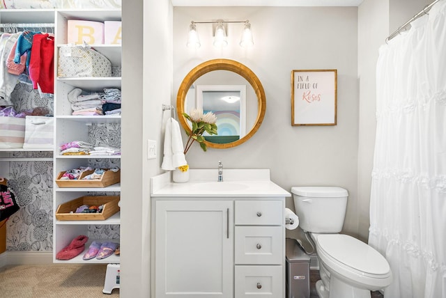 bathroom featuring vanity and toilet