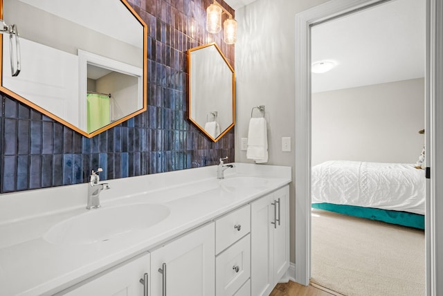 bathroom featuring vanity, tile walls, and backsplash