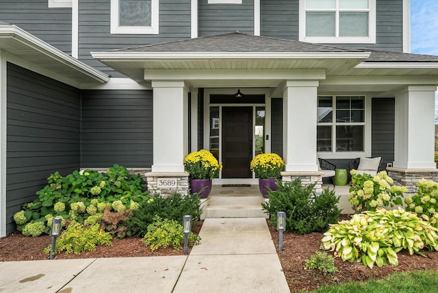 view of exterior entry featuring a porch