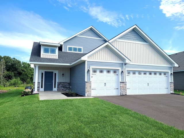 craftsman-style home featuring a front yard and a garage