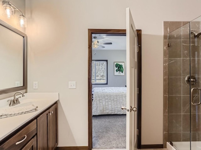 bathroom with vanity, ceiling fan, and a shower with door