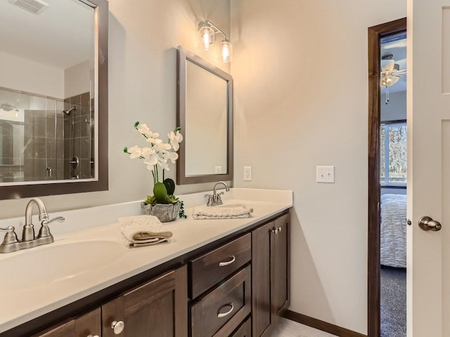 bathroom with ceiling fan, a shower with door, and vanity