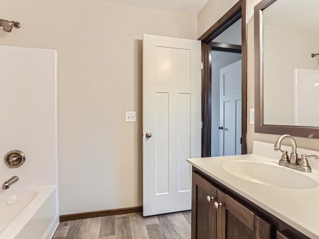 bathroom with vanity, wood-type flooring, and tub / shower combination