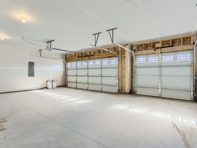 garage with electric panel and a garage door opener