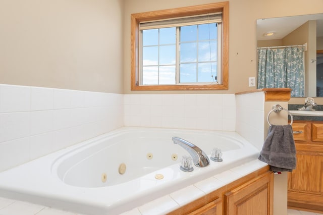 bathroom with sink and tiled bath