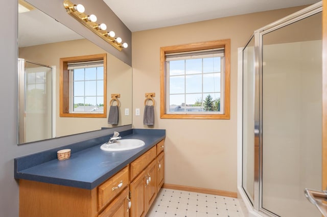 bathroom with vanity and a shower with door