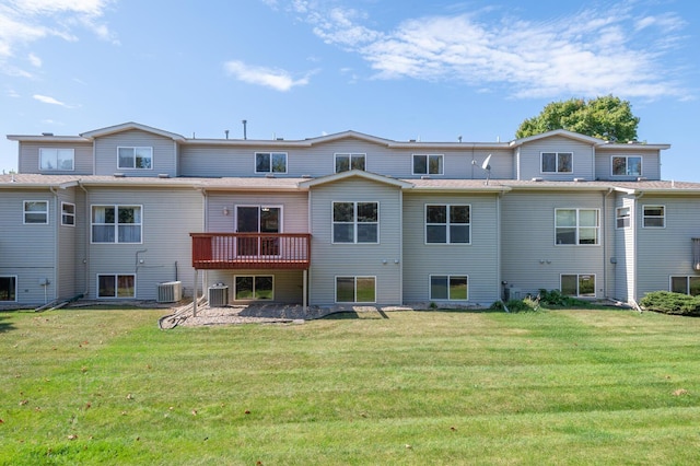 rear view of property with a lawn and central air condition unit