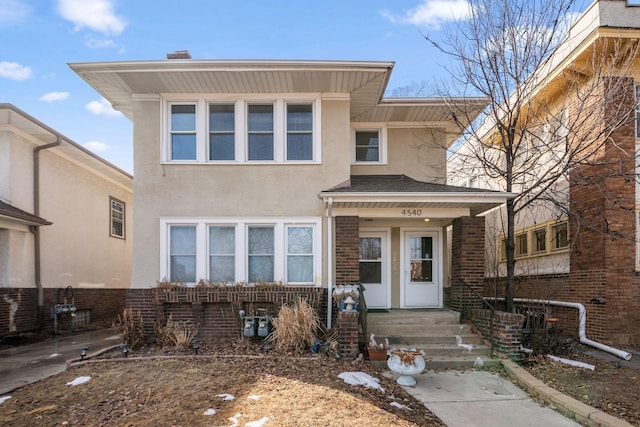 view of front of home with brick siding and stucco siding