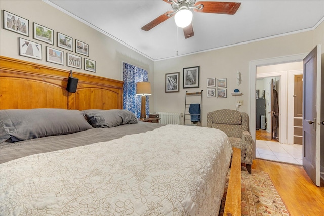 bedroom with ceiling fan, ornamental molding, radiator heating unit, and light wood finished floors