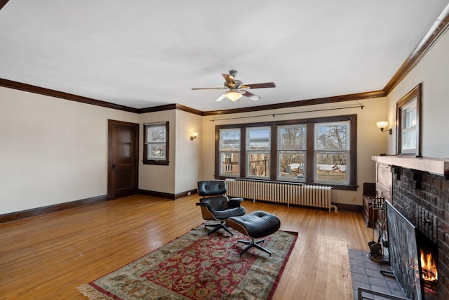 living area with hardwood / wood-style floors, radiator heating unit, a fireplace, and baseboards