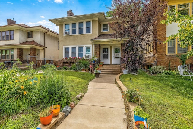 view of front of property with stucco siding, brick siding, a chimney, and a front lawn