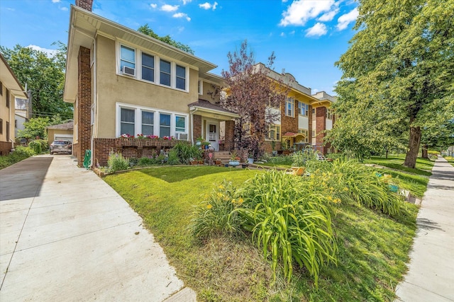 view of front of house with brick siding, stucco siding, a front lawn, an outdoor structure, and a residential view