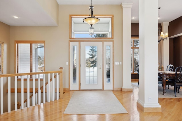 foyer entrance featuring light hardwood / wood-style flooring and a notable chandelier