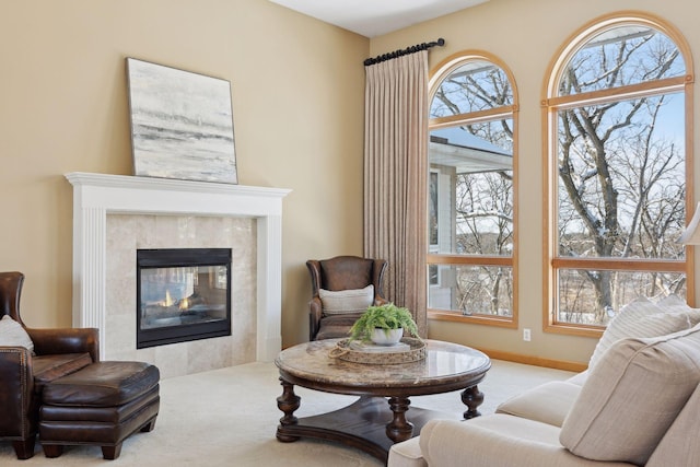 living area with light carpet and a fireplace