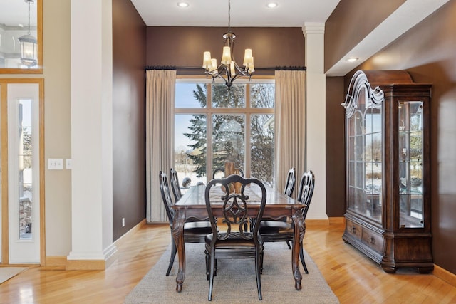 dining area featuring light hardwood / wood-style floors and a chandelier