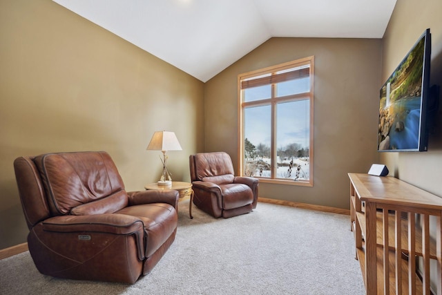 living area featuring lofted ceiling and carpet flooring