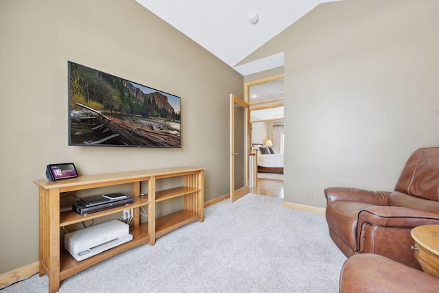 living area with vaulted ceiling and light colored carpet