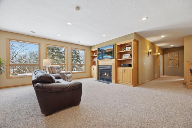 living room with a wealth of natural light, light carpet, and built in shelves