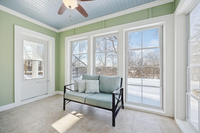 sunroom / solarium featuring ceiling fan