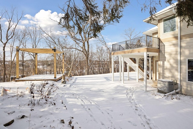 yard layered in snow with a deck