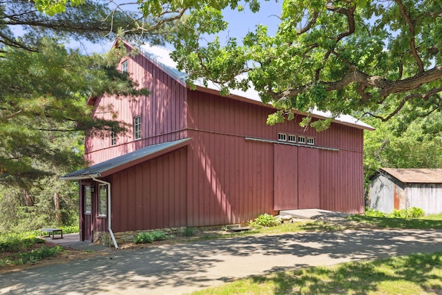 view of side of property with an outbuilding