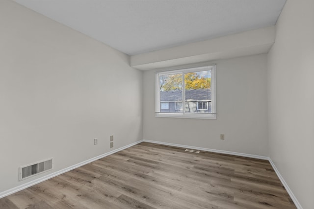 unfurnished room with light wood-type flooring