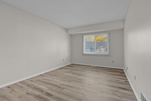 spare room with light hardwood / wood-style flooring