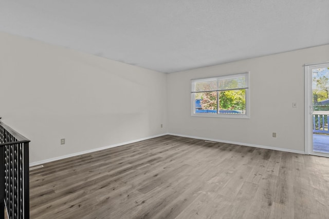 spare room featuring wood-type flooring