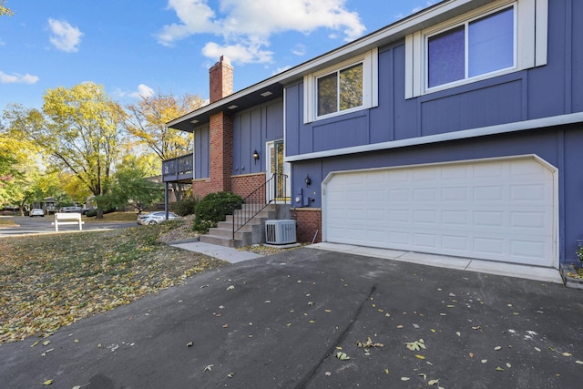 bi-level home featuring a garage and central AC