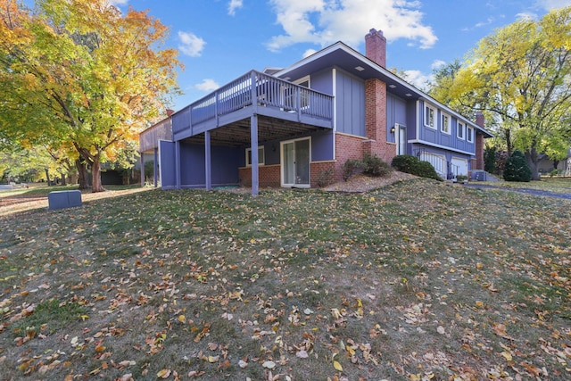 view of property exterior with a yard and a deck